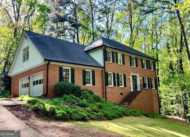 view of front of house featuring brick siding, concrete driveway, and an attached garage