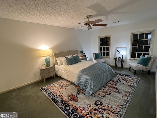 bedroom featuring carpet, baseboards, ceiling fan, and a textured ceiling