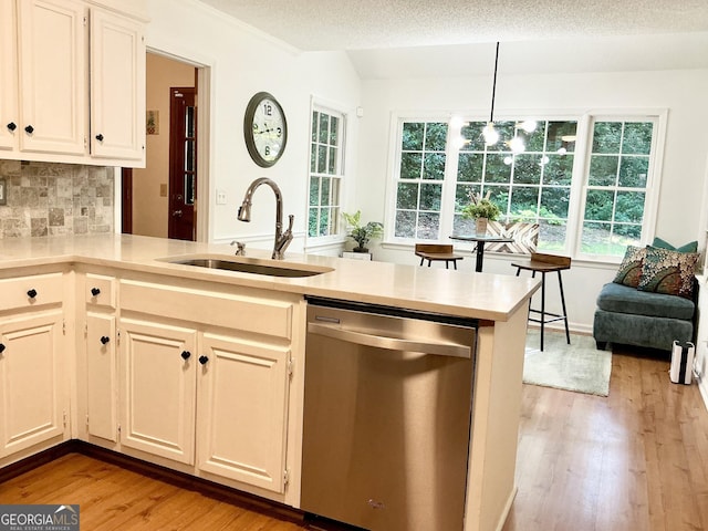 1461 Fox Forest Ter SW, Lilburn, GA 30047 - kitchen with dishwasher, a sink, light wood finished floors, light countertops, and healthy amount of natural light