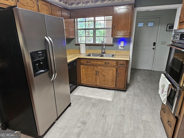 3978 Wc Hodges Rd, Statesboro, GA 30461 - kitchen with black appliances, a sink, light countertops, and light wood finished floors