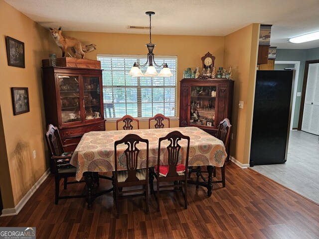 3978 Wc Hodges Rd, Statesboro, GA 30461 - dining area with wood finished floors, baseboards, and a chandelier