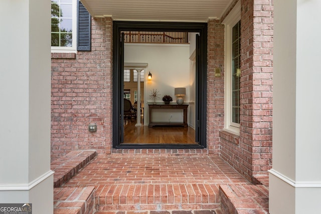 entrance to property featuring brick siding