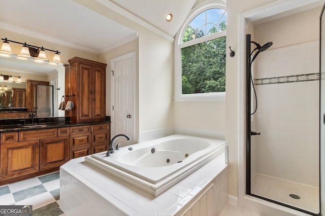 full bathroom with a stall shower, a jetted tub, vanity, ornamental molding, and lofted ceiling