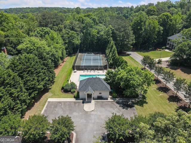 view of subject property featuring a heavily wooded area