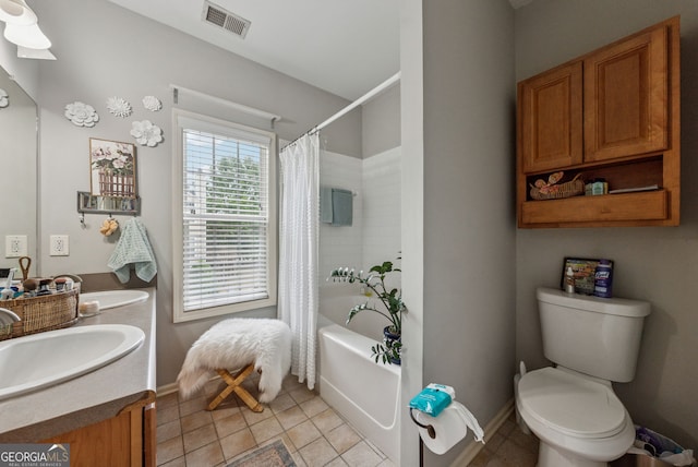 full bathroom with double vanity, shower / bath combo, tile patterned floors, toilet, and baseboards