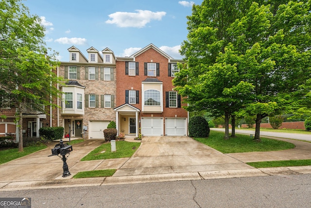 multi unit property with concrete driveway, brick siding, and an attached garage