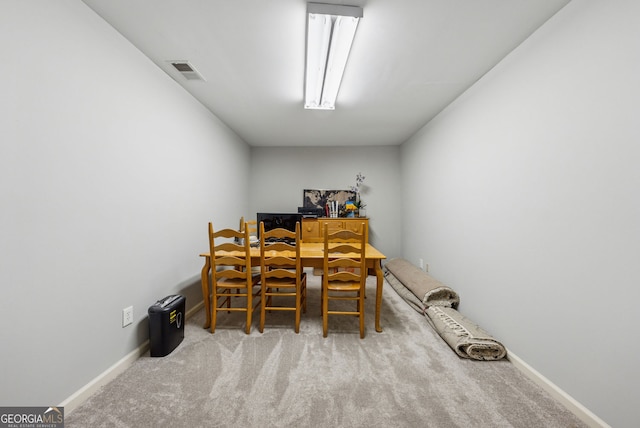carpeted dining area with baseboards