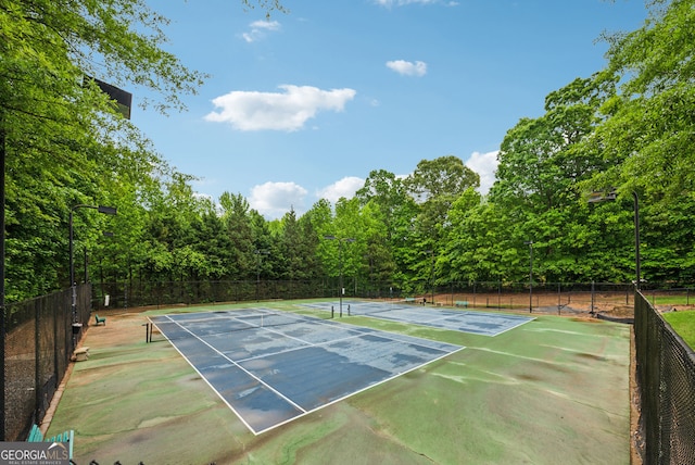 view of tennis court with fence
