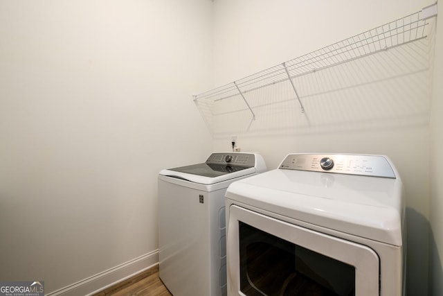6821 Bungalow Rd, Flowery Branch, GA 30542 - laundry area with washer and dryer, wood finished floors, and baseboards