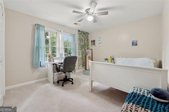 carpeted bedroom featuring baseboards and a ceiling fan