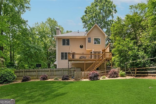 rear view of house with stairway, a chimney, and a wooden deck