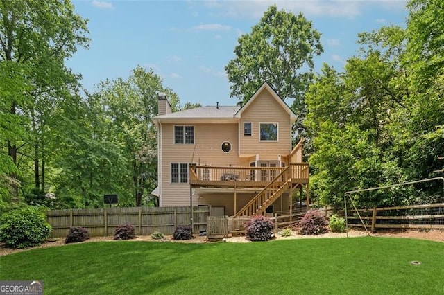 rear view of house with stairs, a chimney, and a wooden deck