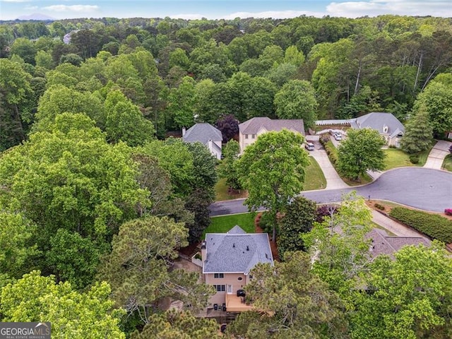 view of property location with a forest