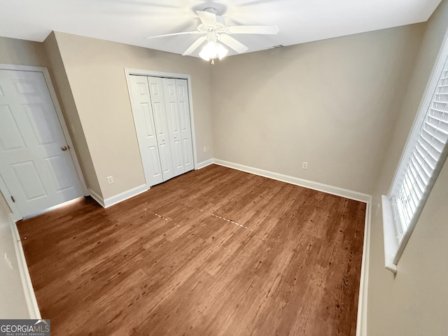 445 Logmont Trce, Athens, GA 30606 - unfurnished bedroom featuring wood finished floors, baseboards, a closet, and a ceiling fan