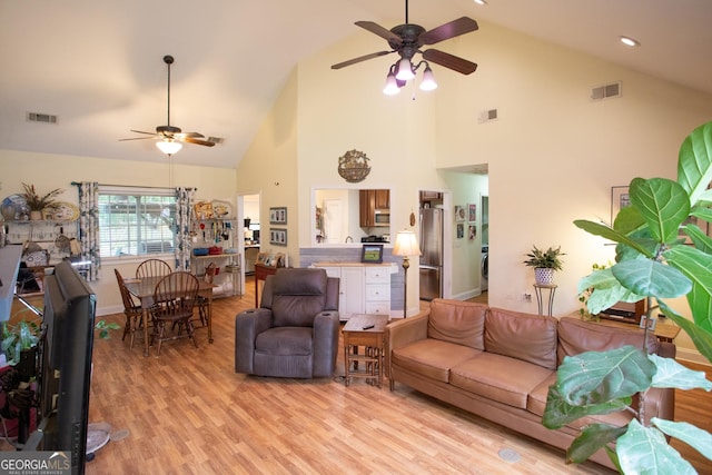 4 E Moore St, Statesboro, GA 30458 - living area with a ceiling fan, high vaulted ceiling, light wood-style flooring, washer / clothes dryer, and baseboards