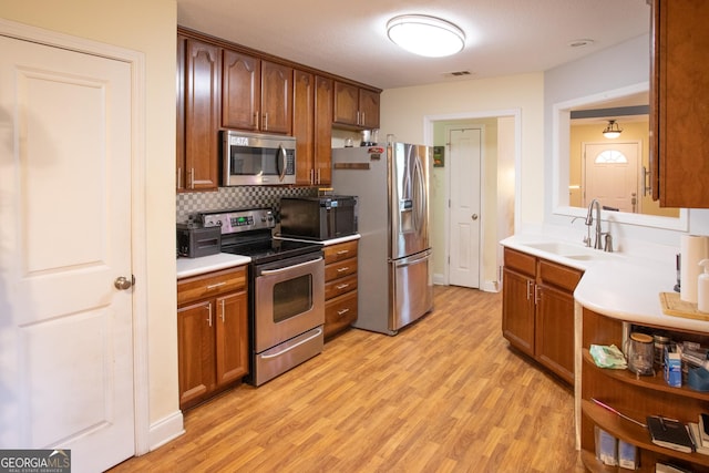 4 E Moore St, Statesboro, GA 30458 - kitchen with stainless steel appliances, a sink, light wood-style flooring, and light countertops