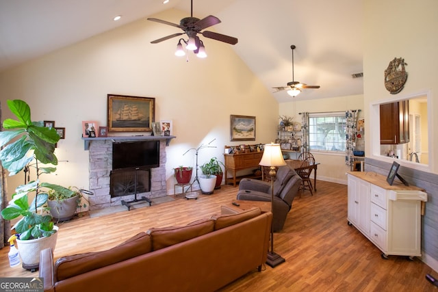 4 E Moore St, Statesboro, GA 30458 - living room with a ceiling fan, high vaulted ceiling, wood finished floors, a stone fireplace, and baseboards