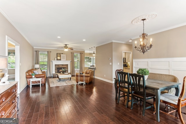 59 Grand Georgian Ct NE, Cartersville, GA 30121 - dining room featuring a chandelier, ceiling fan, a fireplace, dark wood-style flooring, and ornamental molding