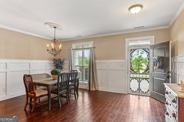 59 Grand Georgian Ct NE, Cartersville, GA 30121 - dining area with a decorative wall, a chandelier, crown molding, dark wood-type flooring, and a wainscoted wall