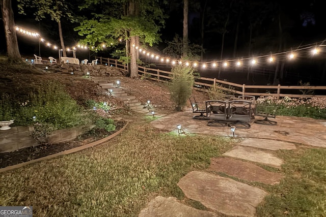 59 Grand Georgian Ct NE, Cartersville, GA 30121 - yard at night featuring a patio area and stairway