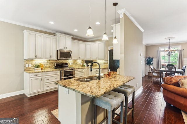 59 Grand Georgian Ct NE, Cartersville, GA 30121 - kitchen featuring appliances with stainless steel finishes, dark wood-style floors, a chandelier, light stone counters, and crown molding