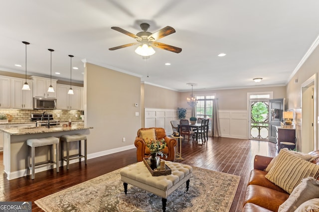 59 Grand Georgian Ct NE, Cartersville, GA 30121 - living area with dark wood finished floors, ceiling fan, ornamental molding, a chandelier, and recessed lighting