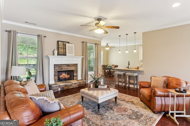 59 Grand Georgian Ct NE, Cartersville, GA 30121 - living area featuring a ceiling fan, wood finished floors, crown molding, and a stone fireplace