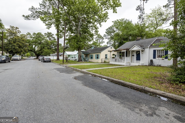 6 Oleander Ave, Savannah, GA 31404 - view of front facade featuring a front lawn, a residential view, and covered porch