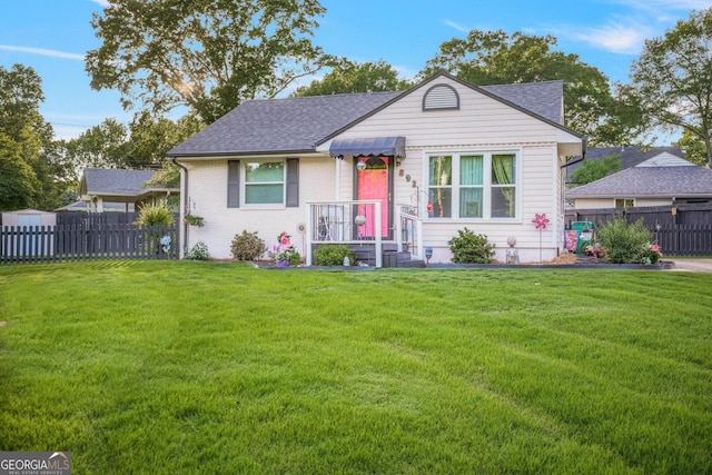bungalow-style house featuring roof with shingles and brick siding