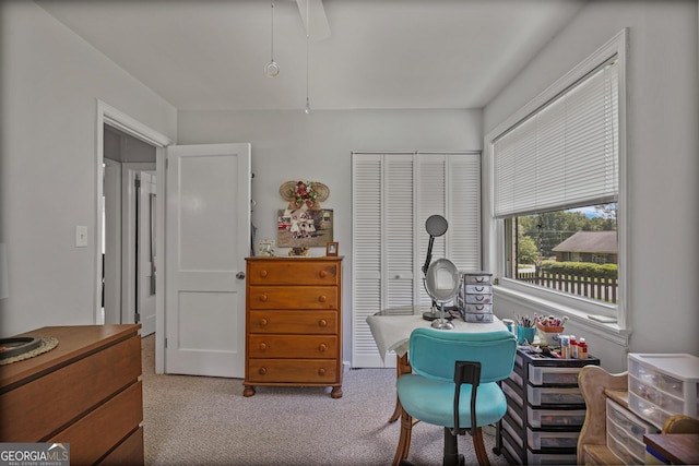 carpeted bedroom featuring a closet and ceiling fan