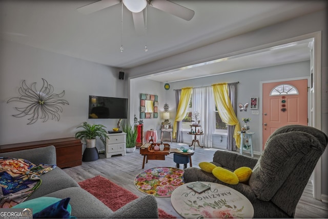 living area featuring wood finished floors and a ceiling fan