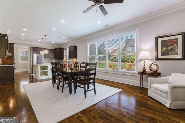 dining room featuring ornamental molding, baseboards, a ceiling fan, recessed lighting, and dark wood-type flooring