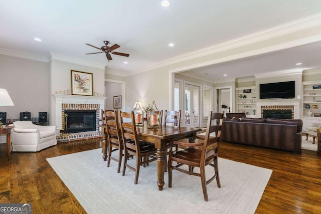 dining room with a fireplace, wood finished floors, ceiling fan, crown molding, and recessed lighting