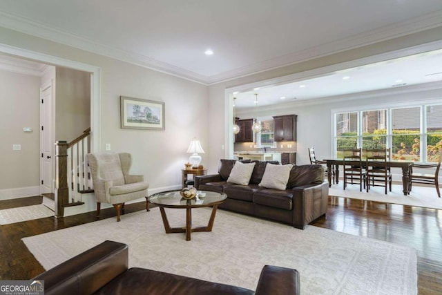 living area with hardwood / wood-style floors, baseboards, stairs, crown molding, and recessed lighting