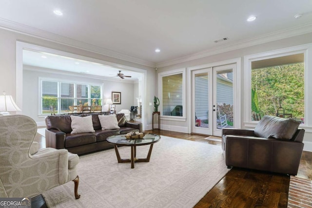 living area featuring wood finished floors, crown molding, recessed lighting, and french doors