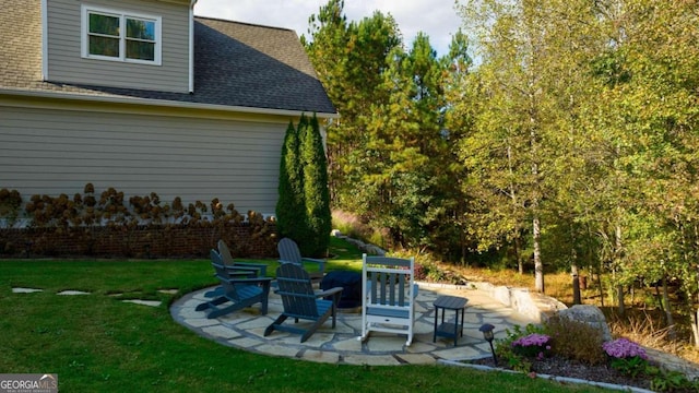 view of grassy yard with a patio