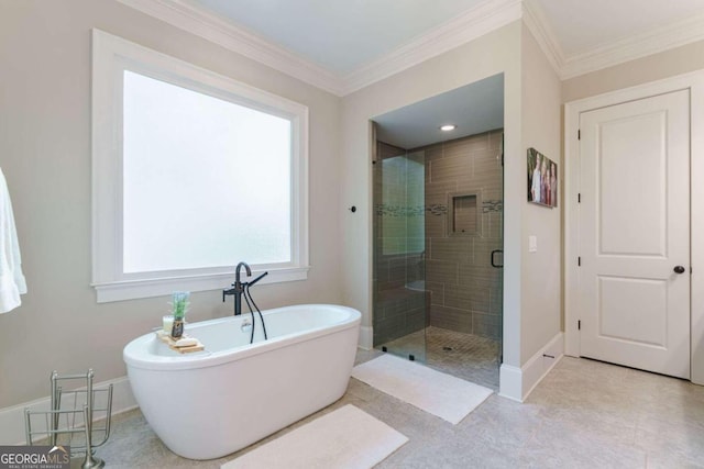 bathroom featuring a shower stall, a soaking tub, crown molding, and baseboards