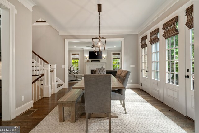 1849 Rock Springs Ln NE, Atlanta, GA 30324 - dining space featuring stairs, wood finished floors, baseboards, crown molding, and a fireplace