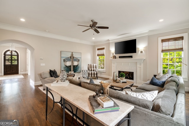 1849 Rock Springs Ln NE, Atlanta, GA 30324 - living area with arched walkways, healthy amount of natural light, a ceiling fan, dark wood finished floors, and crown molding