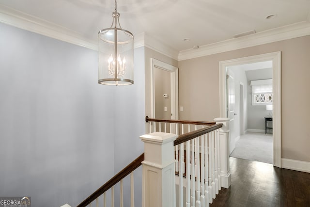 1849 Rock Springs Ln NE, Atlanta, GA 30324 - corridor featuring an upstairs landing, ornamental molding, a chandelier, dark wood-style flooring, and baseboards