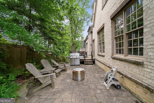 1849 Rock Springs Ln NE, Atlanta, GA 30324 - view of patio with an outdoor fire pit, grilling area, fence, and a wooden deck
