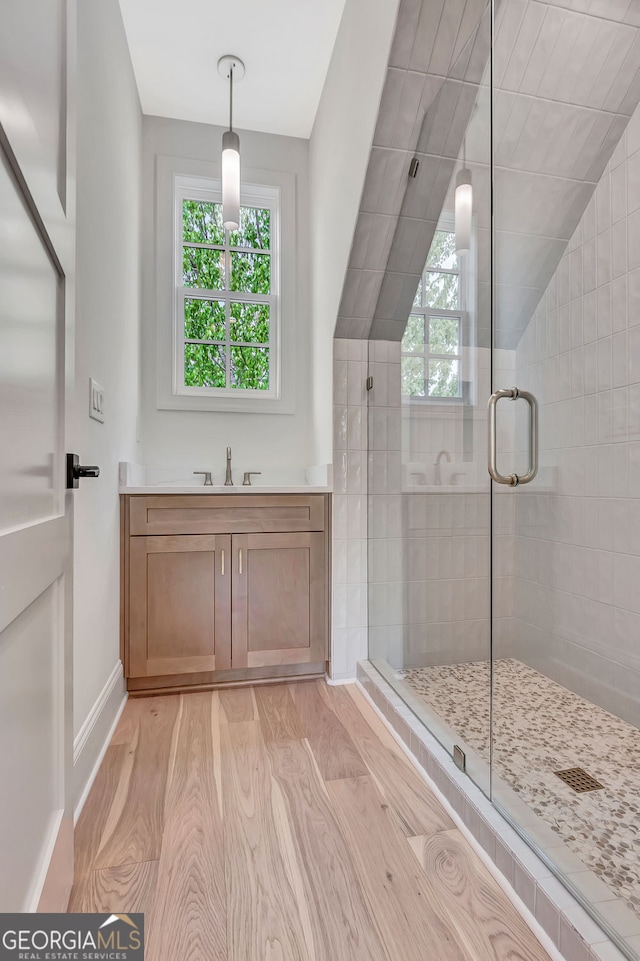 126 Morgan St, Senoia, GA 30276 - full bathroom with wood finished floors, a shower stall, vanity, baseboards, and lofted ceiling