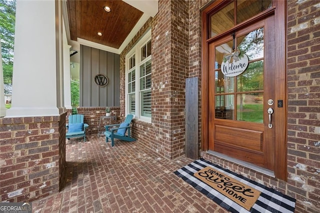 116 Serenity Lake Dr, Alpharetta, GA 30004 - property entrance featuring a porch, brick siding, and board and batten siding