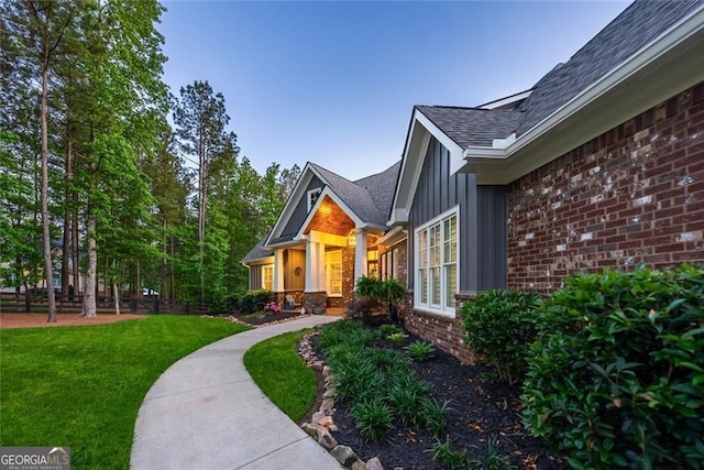 116 Serenity Lake Dr, Alpharetta, GA 30004 - property entrance with a lawn, board and batten siding, brick siding, and a shingled roof
