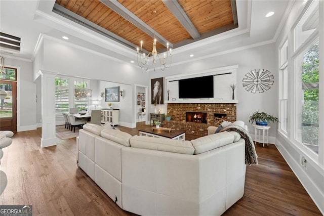 116 Serenity Lake Dr, Alpharetta, GA 30004 - living area featuring decorative columns, a chandelier, wood ceiling with exposed beams, wood finished floors, and baseboards