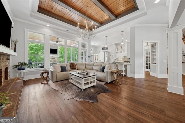 116 Serenity Lake Dr, Alpharetta, GA 30004 - living area with a brick fireplace, a wood ceiling with exposed beams, wood finished floors, a chandelier, and crown molding