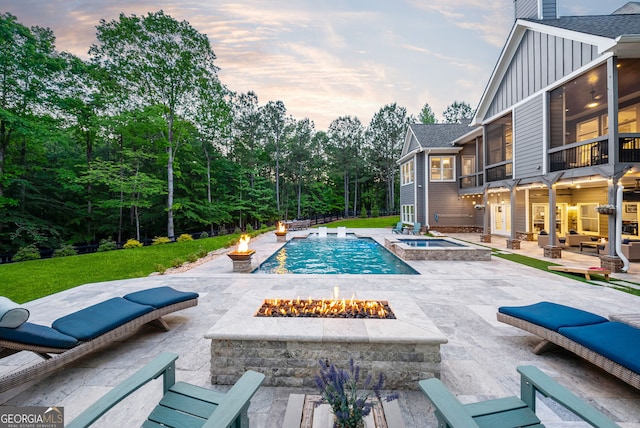 116 Serenity Lake Dr, Alpharetta, GA 30004 - view of swimming pool with an outdoor fire pit, a patio area, a pool with connected hot tub, and a sunroom