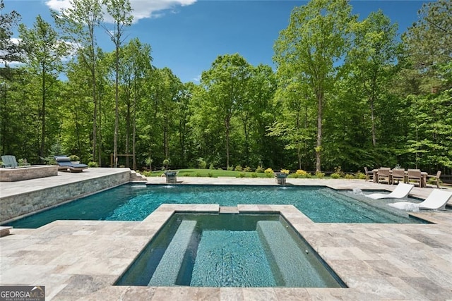 116 Serenity Lake Dr, Alpharetta, GA 30004 - view of swimming pool with a patio, a pool with connected hot tub, and a wooded view