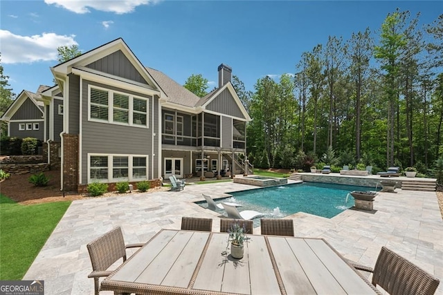 116 Serenity Lake Dr, Alpharetta, GA 30004 - view of swimming pool with a sunroom, a patio area, outdoor dining space, and a pool with connected hot tub