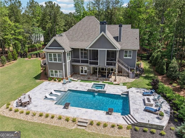 116 Serenity Lake Dr, Alpharetta, GA 30004 - rear view of property with a sunroom, a chimney, stairway, roof with shingles, and a patio area